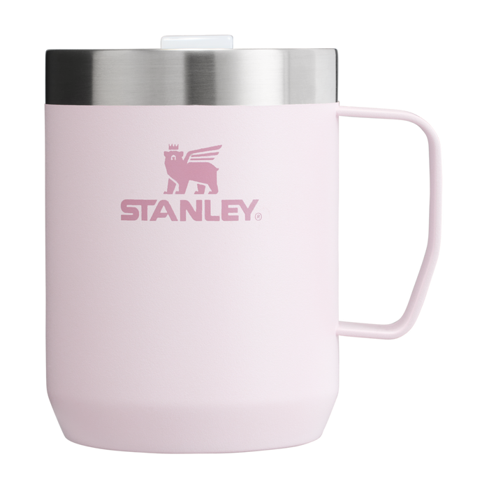 A pink Stanley camp mug with a stainless steel rim and a handle, featuring the Stanley logo on the front.
