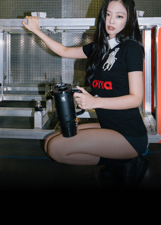Person holding a black container in a kitchen setting