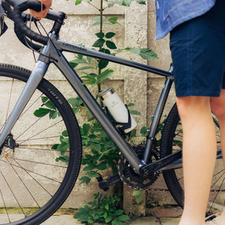 Front shot camera of a model's bike focusing on the Transit Mug